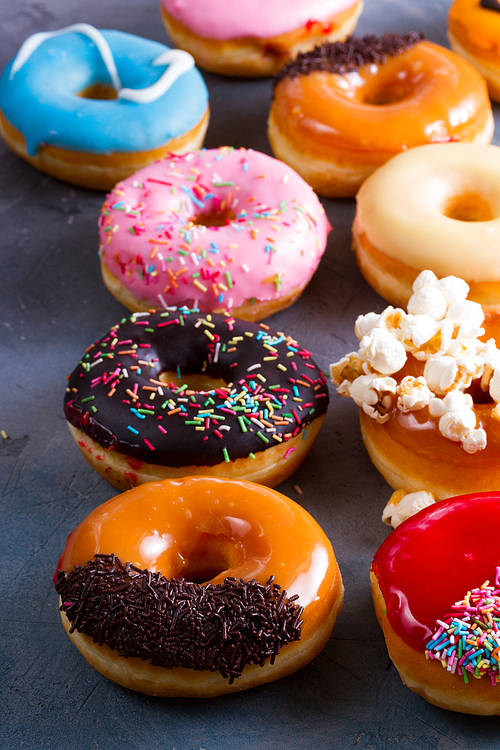 mix of sweet donuts on gray stone background