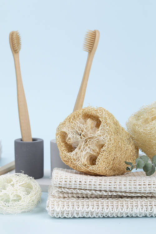 Zero Waste - Bamboo toothbrush in a gypsum toothbrush holder, close-up cross-section of natural loofahs