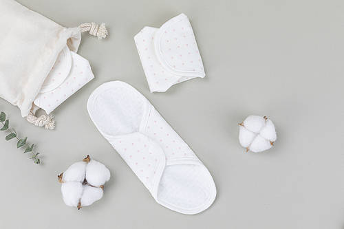 Zero waist-gray background, cotton wool and natural cotton sanitary pads coming out of the pocket, top side