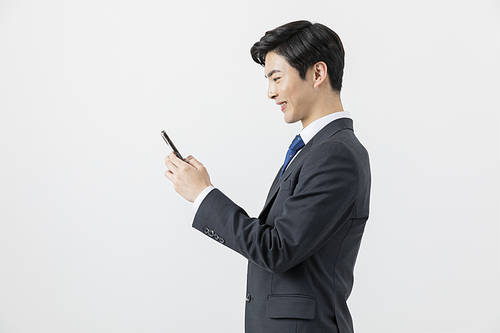 Smart office worker - Side view of office worker checking smartphone