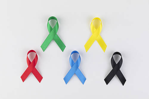 Ribbon image - red, green, blue, yellow and black ribbons laid out on a white background