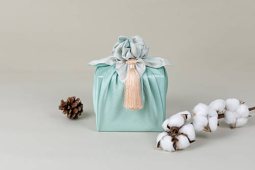 Holiday gift box_box wrapped in cotton wool and pine cone furoshiki and front image photo