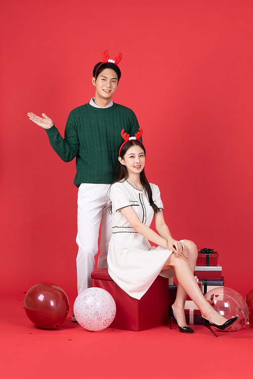 Rudolph Headband Christmas Shopping Event Concept Photo of Couple Posing