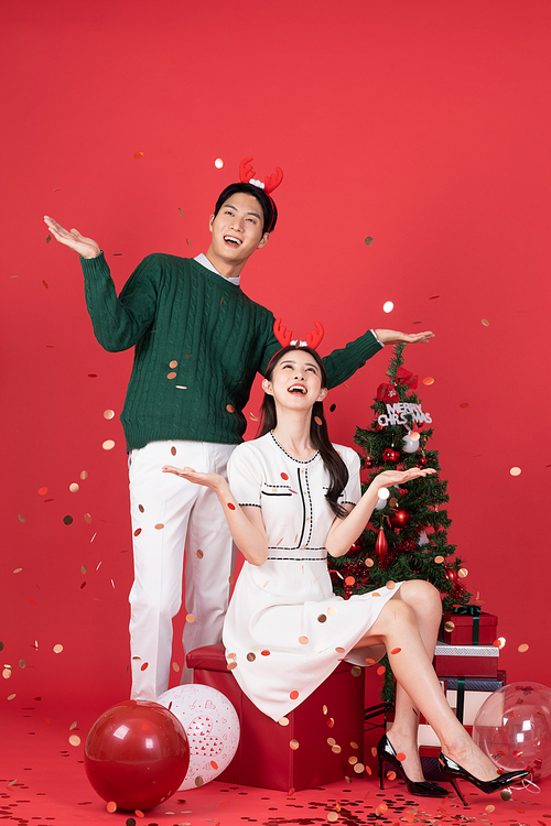 Rudolph Headband Christmas Shopping Event Concept Photo of a couple posing with kenpetti firecrackers