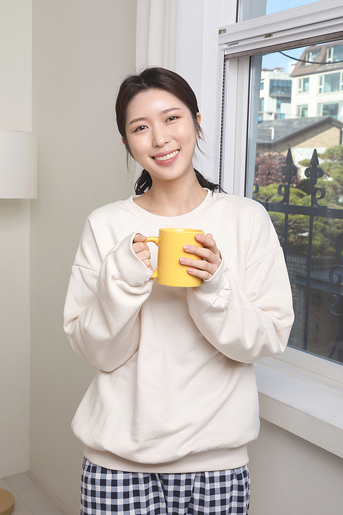 Winter Indoor Daily Life_Photo of a woman drinking tea by the window