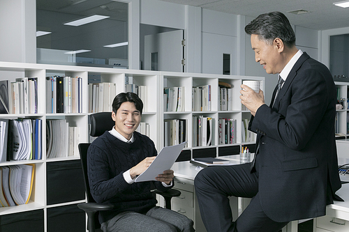 Two men _ Photo talking while drinking coffee