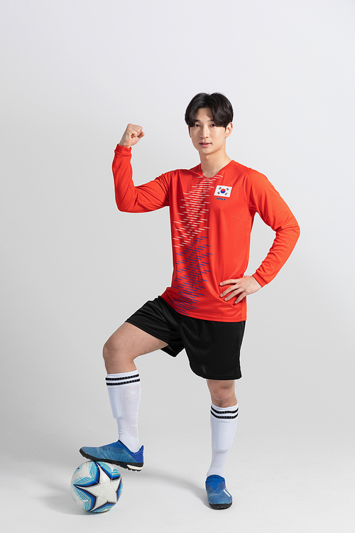 Sports_Hobbies Football Male player holding a soccer ball photo image