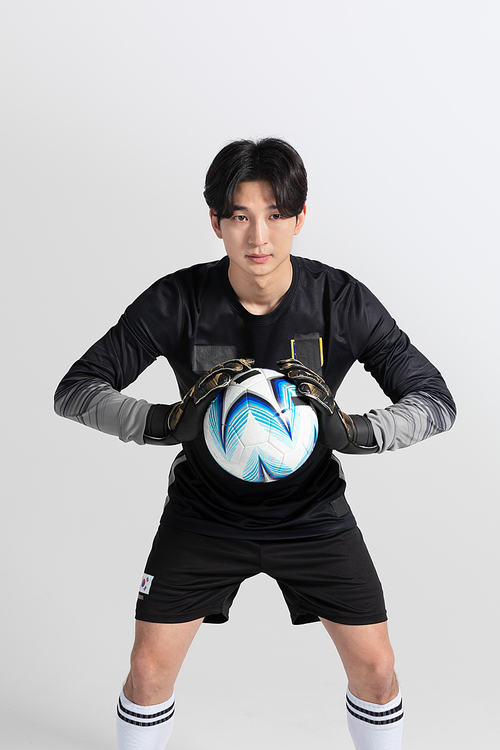 Sports_Hobbies Football Male player holding a soccer ball photo image