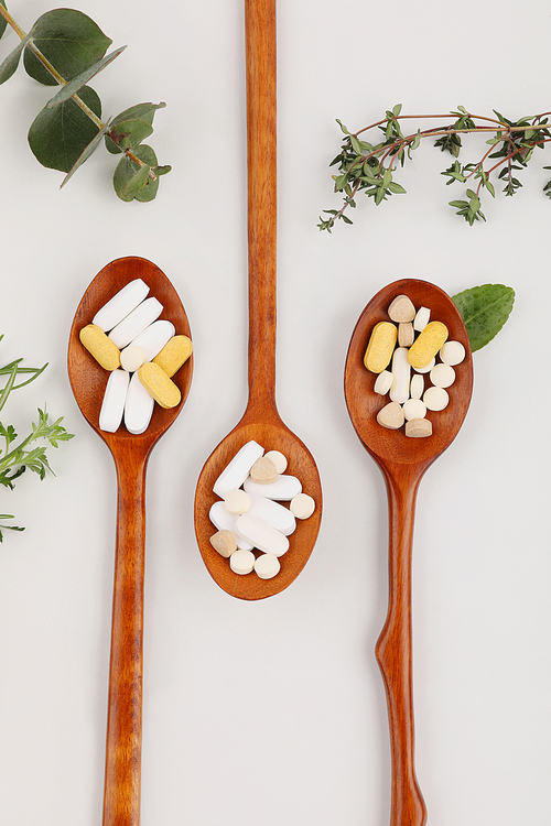 Health supplements_ wooden spoons and pills