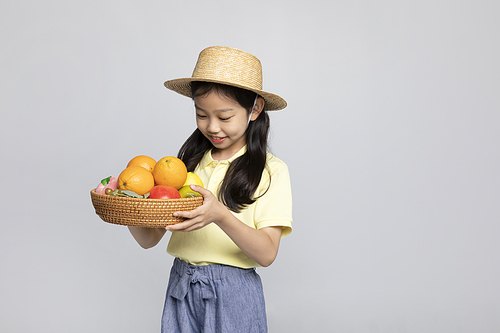 Photo image of a child_holding a fruit basket