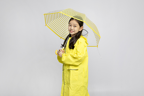 Child_Picture image of children wearing raincoats and umbrellas