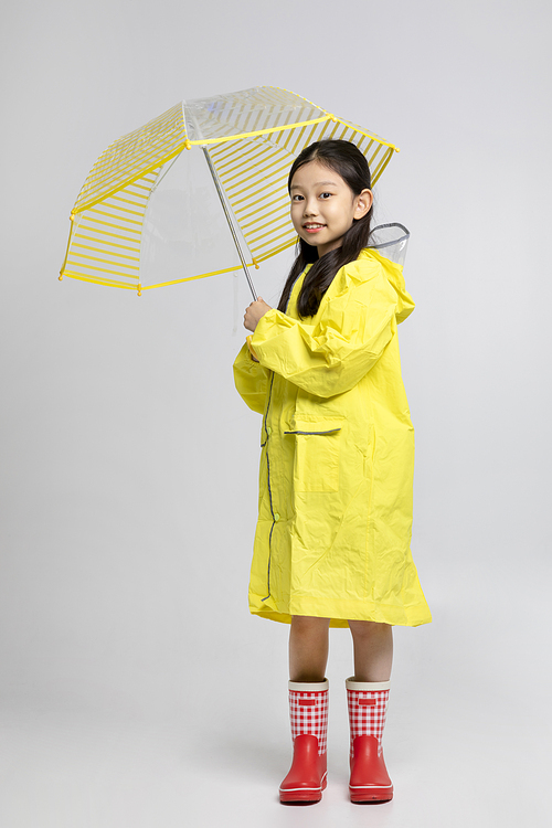 Child_Picture image of children wearing raincoats and umbrellas