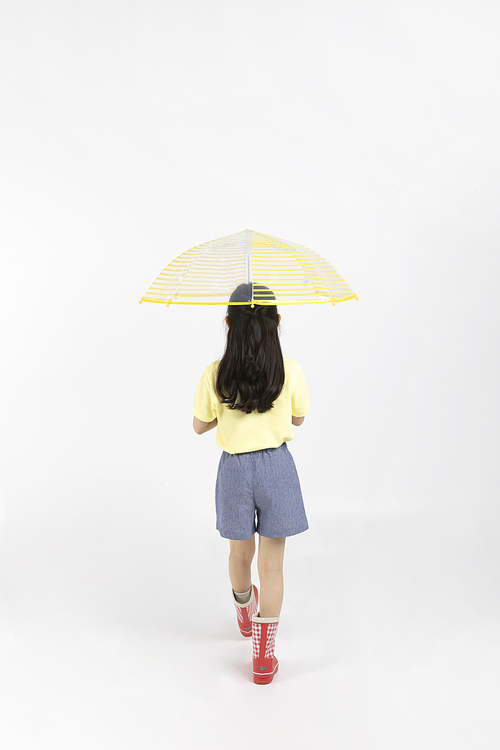 Child_Picture image of a back view wearing boots and holding an umbrella