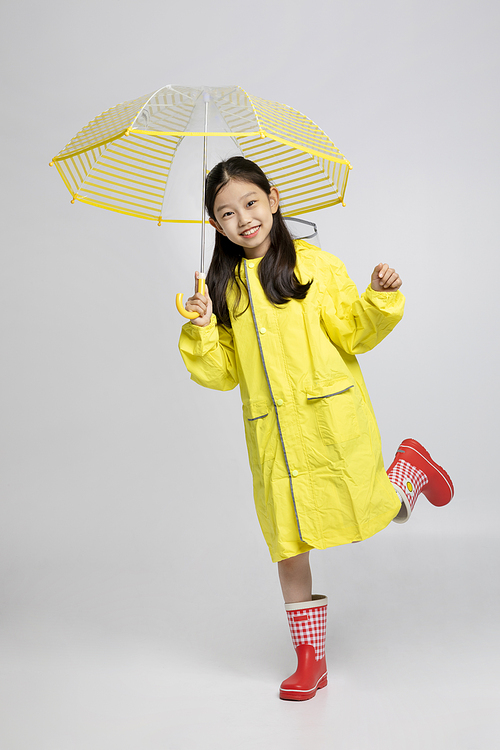 Child_Picture image of children wearing raincoats and umbrellas
