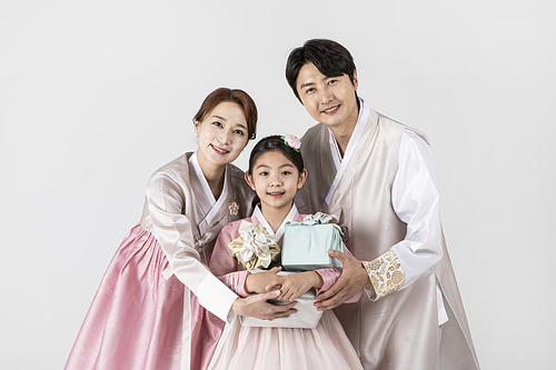 Photo image of family_holding presents