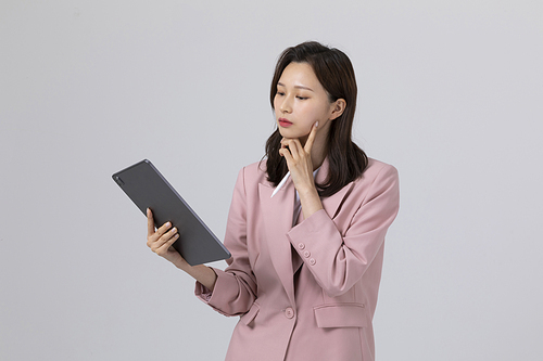 Photo image of a young man who is thinking about holding a tablet