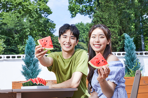 Summer daily life_Photo image of men and women serving watermelon outdoors