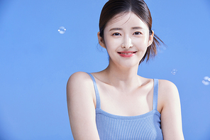 Photo image of a smiling woman with soap bubbles