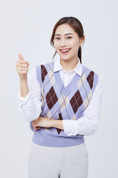 Business woman_Photo image of an office worker woman wearing an employee ID card around her neck and holding her thumb up