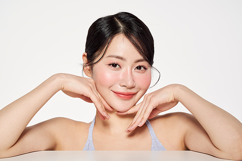 Asian woman posing touching her face