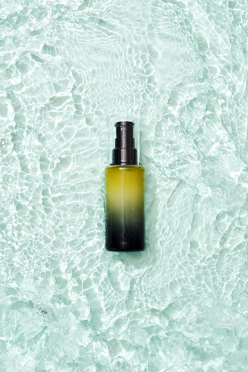 Gradient ampoule bottle placed on a wave background