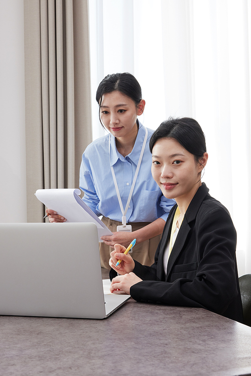 Two business women in a conference room