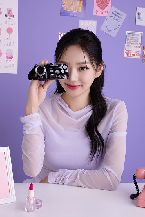 A woman in her 20s holding various poses while holding kitschy items.