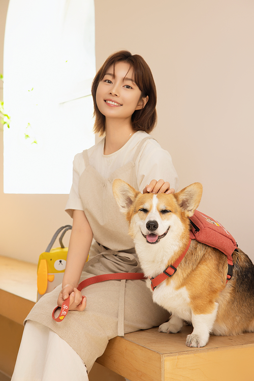 A woman sitting with a puppy
