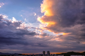 Clouds in the sunset covering the city
