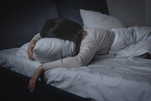 awake woman having insomnia and lying on pillow at night