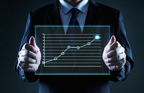 Businessman holding a screen glass with grow up financial state chart, business growth ideal concept .